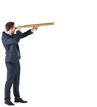 Businessman Standing And Looking Through Telescope