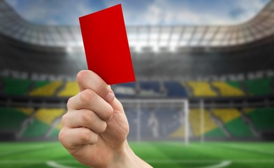 Poster - Composite image of hand holding up red card
