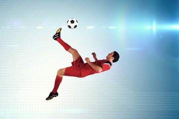 Poster - Composite image of football player in red kicking