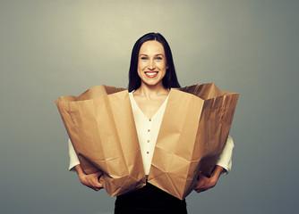 Wall Mural - woman holding paper bags over dark