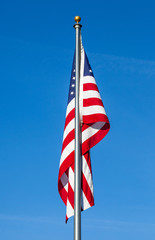 American flag on clear blue sky background