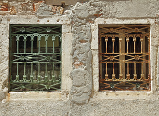 two old windows with decorative metal grid in Venice