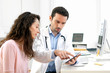 © Production Perig - Doctor using tablet to inform patient
