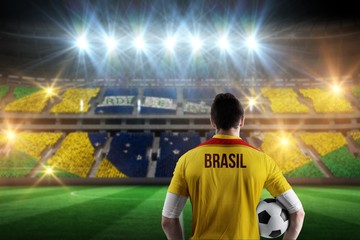 Wall Mural - Composite image of brasil football player holding ball