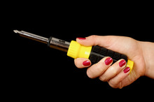 Female Hand Holding Screwdriver Isolated On The Black Background