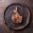 Ribeye Steak with salt and pepper on dark wooden background
