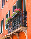 Fototapeta Na drzwi - Picturesque balcony with flowers in an old Italian house