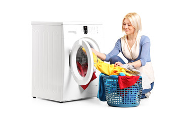 Poster - Woman emptying a washing machine