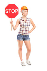 Poster - Female construction worker holding a stop sign