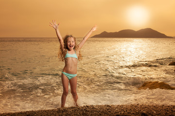 Wall Mural - Girl on beach at sunset