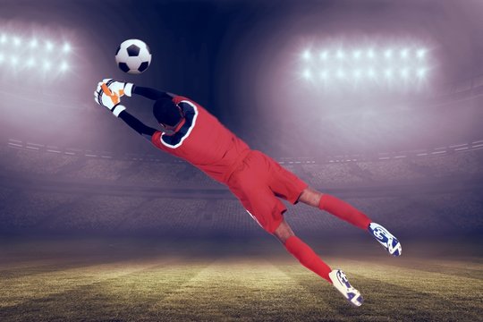 Composite image of goalkeeper in red making a save