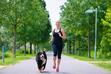 Sports Outdoor - Young Woman Running With Dog In Park