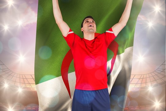 Composite image of excited football player cheering holding alge