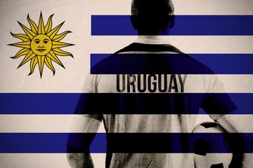 Wall Mural - Composite image of uruguay football player holding ball