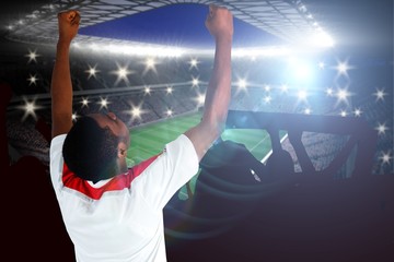 Aufkleber - Composite image of excited handsome football fan cheering