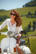 © ZoomTeam - Young beautiful italian woman sitting on a italian scooter in tu