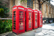 Row of vintage british red telephone boxes
