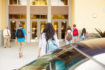 Wall Mural - high school students being dropped off at school by parents