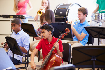 Wall Mural - pupils playing musical instruments in school orchestra