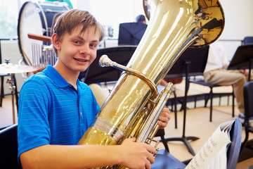 Wall Mural - male pupil playing tuba in high school orchestra
