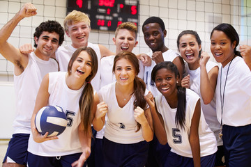 Portrait Of High School Volleyball Team Members With Coach