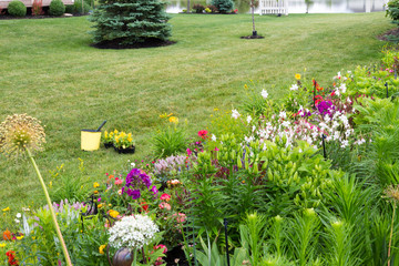 Wall Mural - Planting new flowers in a colorful private garden