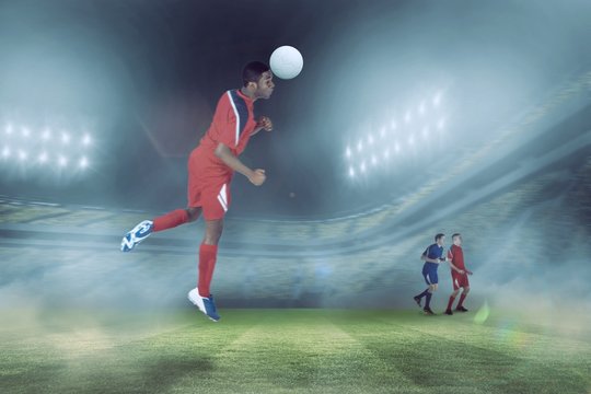 Composite image of football player in red jumping