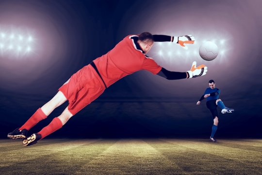 Composite image of fit goal keeper jumping up