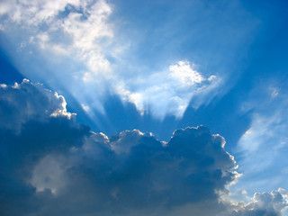 Wall Mural - Blue sky with sun rays through the clouds