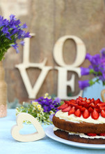 Strawberry Cake With Wildflowers And Decorative Letters On