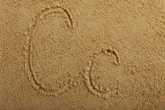 Alphabet letter written on wet beach sand