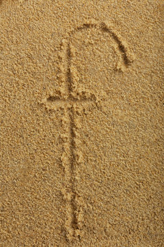 Alphabet letter written on wet beach sand