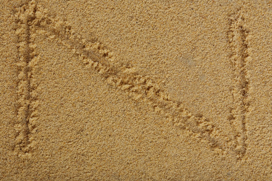 Alphabet letter written on wet beach sand