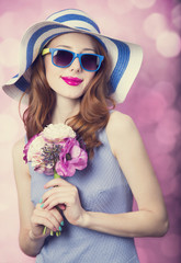 Sticker - Redhead girl with flowers on pink background.