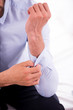 © gstockstudio - Adjusting shirt sleeves.