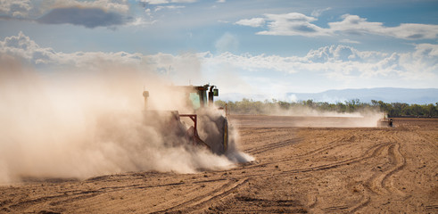 Tractor plowing dry land