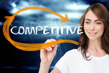 Wall Mural - Businesswoman writing the word competitive