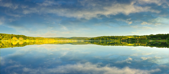 Wall Mural - beautiful yellow rape field, reflected in the lake,
