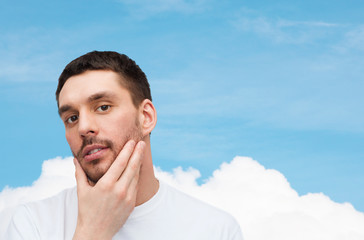 Wall Mural - beautiful calm man touching his face