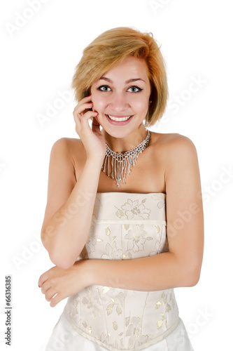 Happy girl in a white evening dress and necklace. Bare shoulders Poster