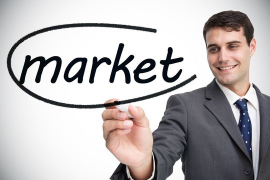 Businessman writing the word market