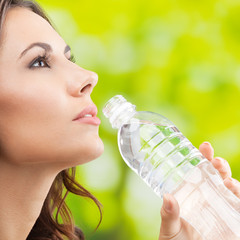 Young woman drinking water, outdoor