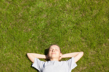 Young Girl Lying On The Grass