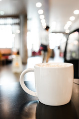 Coffee cup in coffee shop interior