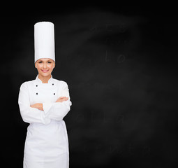 Poster - smiling female chef with crossed arms