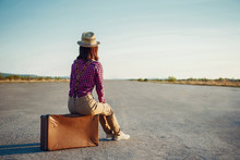 Traveler Girl Sits On Suitcase