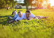 © guas - Happy father and son having fun lying on the grass in summer