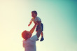 © guas - Happy joyful father throws up in the air child son, family concept, vintage color photo