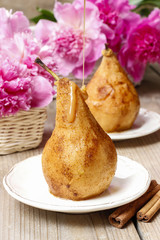 Wall Mural - Pear with caramel, beautiful pink peonies in the background