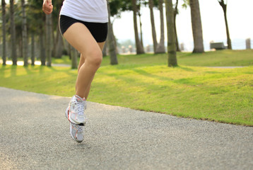 Poster - woman runner athlete running at tropical park